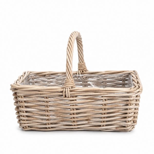 Wicker basket with a curved handle, empty inside, on a white background.