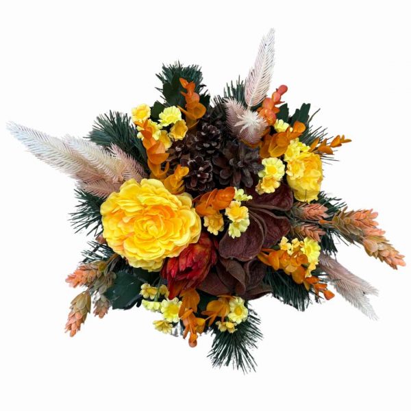 Autumn-themed bouquet with bright yellow blooms, orange accents, pinecones, and evergreen foliage against a white background.
