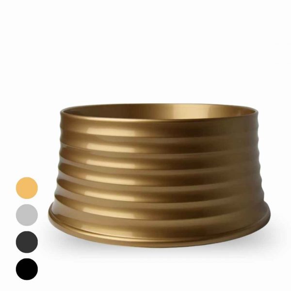 Wide gold ribbed metal bracelet resting on a white background.