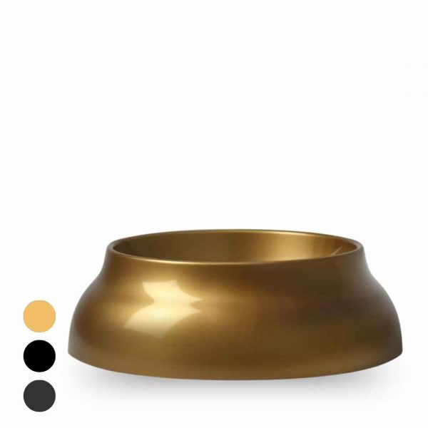 Gold-toned, open-top bowl with a wide, rounded base; decorative piece with color swatches (peach, black, dark gray) to the left.