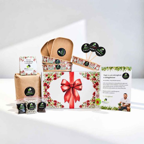Floral gift box with red bow, Micro Green branding, plus sample packets and a brochure on a white surface.